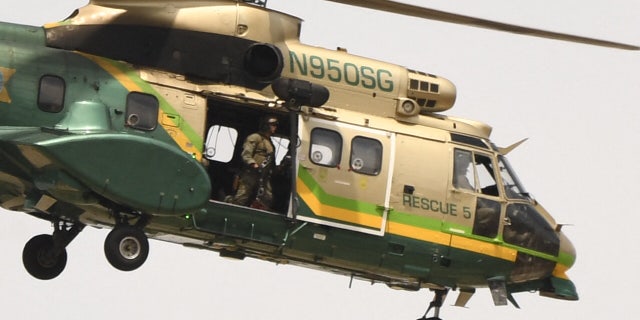 Los Angeles Sheriff’s Office may have to fire 4,000 deputies over vaccination status 4 A Los Angeles Sheriff's Department Rescue 5 Super Puma helicopter circles over a burning house of a suspected gunman of a shooting at a fire station on June 1, 2021 in Acton, California. (Photo by PATRICK T. FALLON / AFP via Getty Images)