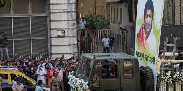 The body of Lata Mangeshkar, is taken for funeral procession outside her house in Mumbai, India, Sunday, Feb.6, 2022. The legendary Indian singer with a prolific, groundbreaking catalog and a voice recognized by a billion people in South Asia, died Sunday morning of multiple organ failure. She was 92.