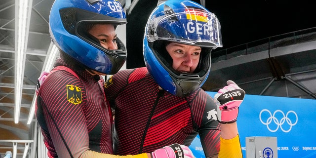 Laura Nolte and Deborah Levi of Germany celebrate a gold medal in the women's bobsled at the 2022 Winter Olympics, Saturday, Feb. 19, 2022, in the Yanqing district of Beijing.