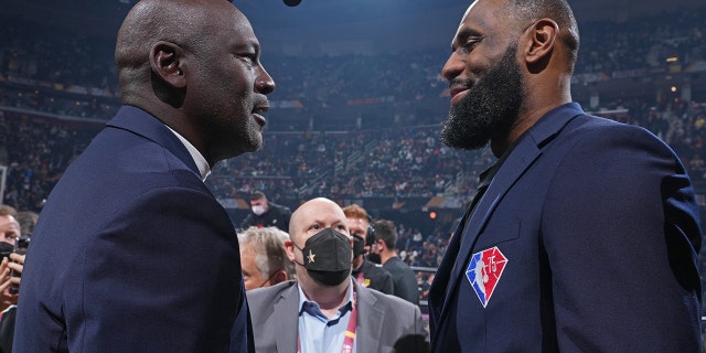 NBA legends Michael Jordan and LeBron James shake hands during the 2022 NBA All-Star Game as part of the 2022 NBA All-Star Weekend on February 20, 2022 at Rocket Mortgage FieldHouse in Cleveland, Ohio.