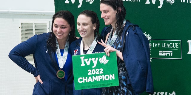 University of Pennsylvania swimmer Lia Thomas, right smiling on the podium after winning the 500 freestyle during the 2022 Ivy League Womens Swimming and Diving Championships at Blodgett Pool on February 17, 2022, in Cambridge, Massachusetts.