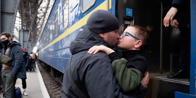 A painful parting for this father and son in Lviv, Ukraine, is captured here as a Ukrainian father must bid his young son goodbye. The dad had to send his young family off to Hungary — while he stayed behind in Ukraine to help ward off the Russian attacks on his country along with thousands of other Ukrainian men. 