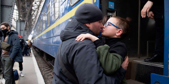 A painful parting for this father and son in Lviv, Ukraine, is captured here as a Ukrainian father must bid his young son goodbye. The dad had to send his young family off to Hungary — while he stayed behind in Ukraine to help ward off the Russian attacks on his country along with thousands of other Ukrainian men. 