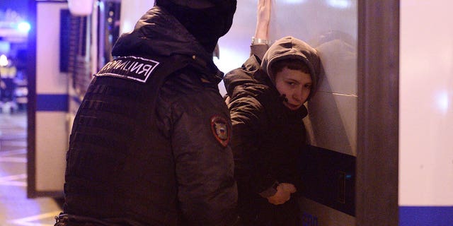 A person is detained by police during an anti-war protest, after Russia launched a massive military operation against Ukraine, in Moscow, Russia, February 24, 2022.
