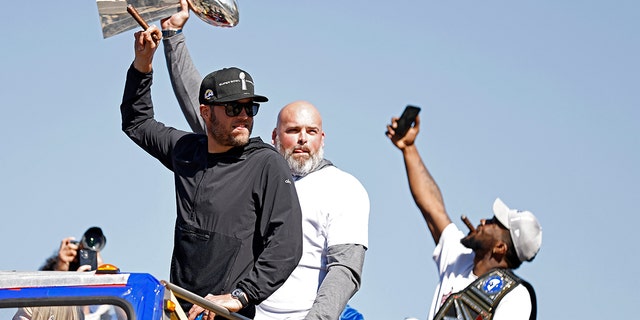 Matthew Stafford (left) and Andrew Whitworth (center) of the Los Angeles Rams celebrate during the Super Bowl LVI Victory Parade on Feb. 16, 2022, in Los Angeles, California.