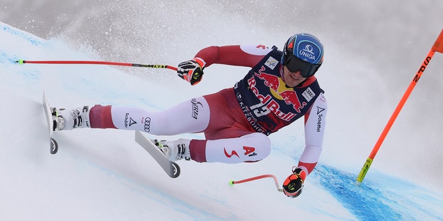 Austria's Matthias Mayer speeds down the course during an alpine ski, men's World Cup downhill, in Kitzbuehel, Austria, Sunday, Jan. 23, 2022.