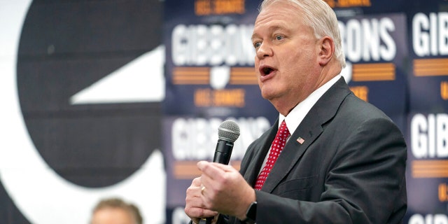 Mike Gibbons, a Republican Senate candidate for Ohio, speaks to supporters as Sen. Rand Paul, R-Ky., looks on during a campaign rally in Maineville, Ohio, Friday, Jan. 14, 2022.