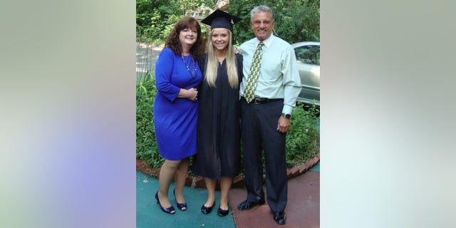 Jessica with her parents at graduation. 