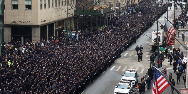 New York Police officers line up along Fifth Avenue outside St. Patrick's Cathedral for Officer Wilbert Mora's funeral Feb. 2, 2022, in New York.
