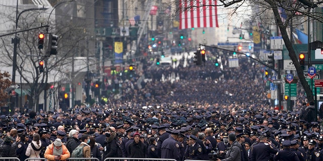 New York Police officers gather along Fifth Avenue outside St. Patrick's Cathedral for Officer Wilbert Mora's funeral, Wednesday, Feb. 2, 2022, in New York. 