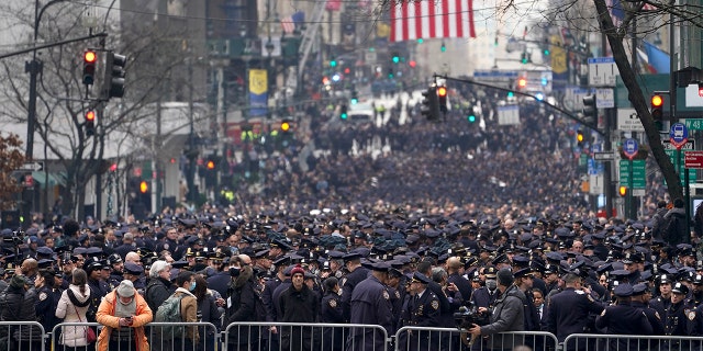 New York Police officers gather along Fifth Avenue outside St. Patrick's Cathedral for Officer Wilbert Mora's funeral, Wednesday, Feb. 2, 2022, in New York. 