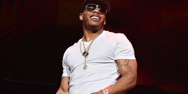 Nelly surprised a fan by giving him the jacket off his back at a recent concert.