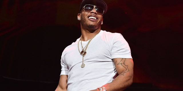 Nelly surprised a fan by giving him the jacket off his back at a recent concert.