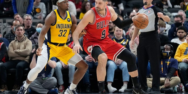 Chicago Bulls center Nikola Vucevic (9) moves to the basket in front of Indiana Pacers guard Terry Taylor (32) during the first half of an NBA basketball game in Indianapolis, Friday, Feb. 4, 2022.