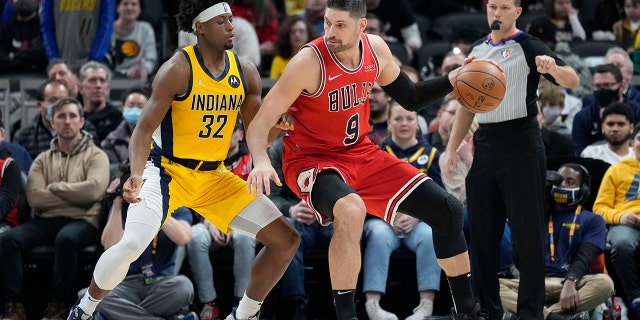 Chicago Bulls center Nikola Vucevic (9) moves to the basket in front of Indiana Pacers guard Terry Taylor (32) during the first half of an NBA basketball game in Indianapolis, Friday, Feb. 4, 2022.