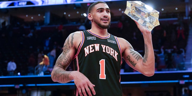 New York Knocks Obi Toppin holds up the trophy after winning the dunk contest part of the skills challenge competition, part of NBA All-Star basketball game weekend, Saturday, Feb. 19, 2022, in Cleveland.