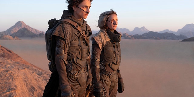 This image released by Warner Bros. Pictures shows Timothee Chalamet, left, and Rebecca Ferguson in a scene from "Dune."