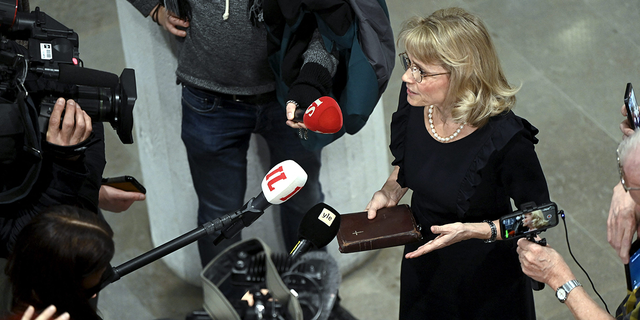 MP of the Finland's Christian Democrats Paivi Rasanen holds a bible as she speaks to media ahead of a court session at the Helsinki District Court in Helsinki, Finland.