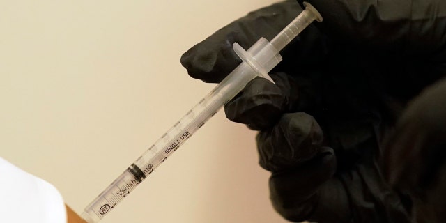 A person is injected with her second dose of the Pfizer COVID-19 vaccine at a Dallas County Health and Human Services vaccination site in Dallas, Thursday, Aug. 26, 2021. Federal health regulators on Friday, Feb. 11, 2022 delayed next week’s public meeting to review Pfizer’s COVID-19 vaccine for children under 5, saying they want to see more data. (AP Photo/LM Otero, File)