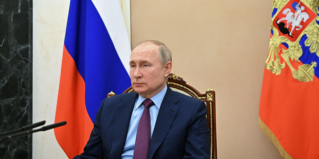Russian President Vladimir Putin is attending a meeting with Russian Defense Minister Sergei Shoigu at the Kremlin in Moscow on February 14, 2022.