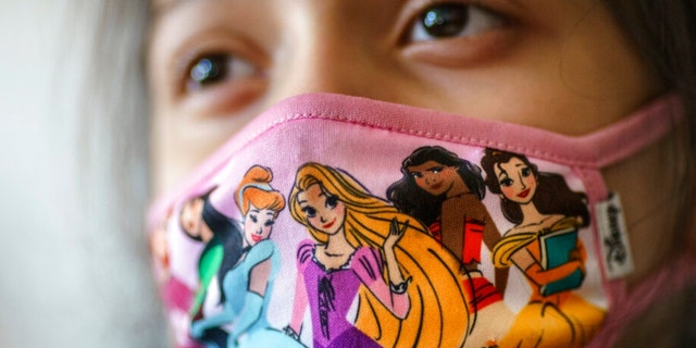 A student wears a mask during class at Raices Dual Language Academy, a public school in Central Falls, R.I., Wednesday, Feb. 9, 2022. (AP Photo/David Goldman) 