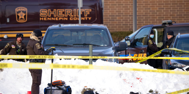 Investigators from Hennepin County Sheriff's Office process the scene of a shooting, Tuesday, Feb. 1, 2022, at the South Education Center, an alternative school in Richfield, Minn. 