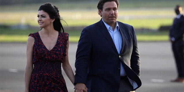 Florida Gov. Ron DeSantis and his wife, Casey DeSantis, walk at Ocala International Airport in Ocala, Florida, Oct. 23, 2020.