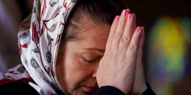 Iryna Hetman-Piatkovska prays for her son who is a soldier in Ukraine during a service for Ukraine at the Saint Andrew Ukrainian Orthodox Church of Los Angeles Sunday, Feb. 27, 2022.