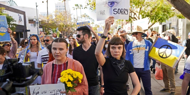 Russina citizen Katrina Repina, right, holds a sign that reads: "I'm Russian, No War. I'm sorry," as she expresses her support to Ukraine in Santa Monica's Third Street Promenade in Santa Monica, Calif., Sunday, Feb. 27, 2022.