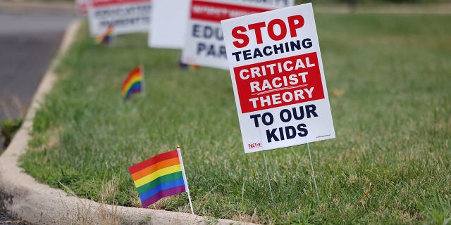 Signs opposing Critical Race Theory line the entrance to the Loudoun County School Board headquarters, in Ashburn, Virginia, U.S. June 22, 2021. REUTERS/Evelyn Hockstein