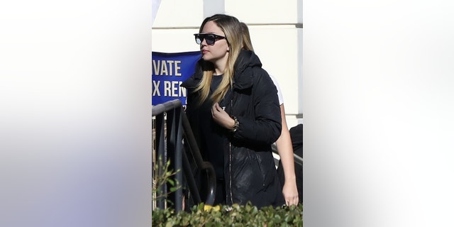 Amanda Bynes picks up Starbucks before her one hour indoor cycling class with a friend in 2018. Bynes kept it casual in an all black athleisure ensemble, complete with a Life of Pablo shirt, as she makes her way down the street with a friend.