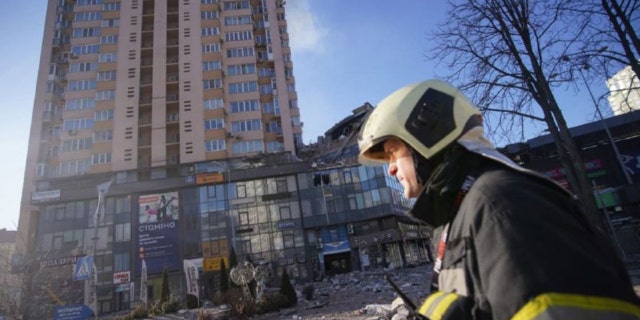 Rubble can be seen below a high-rise apartment building that the government says was hit by a missile overnight.