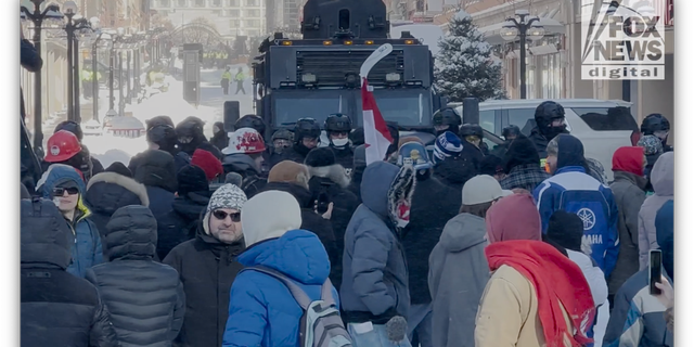"Freedom Convoy" protestors line up in front of police. (Fox News Digital/Jon Michael Raasch)