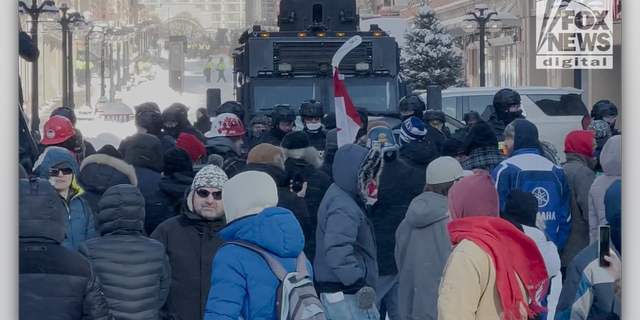 "Freedom Convoy" protestors line up in front of police. (Fox News Digital/Jon Michael Raasch)