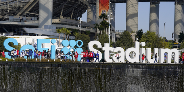 Fans make their way to SoFi Stadium before the NFC championship game between the Los Angeles Rams and the San Francisco 49ers in Inglewood, Calif.