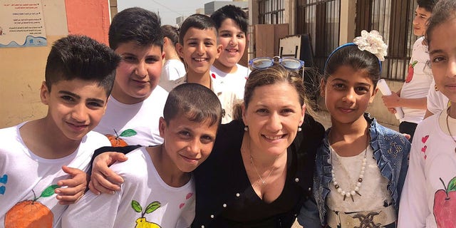 Tina Ramirez, president and executive director of Hardwired Global, meeting with Iraqi kids in Iraq.