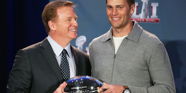 NFL commissioner Roger Goodell presents New England Patriots quarterback Tom Brady the Super Bowl MVP trophy in Houston on Feb. 6, 2017. The Patriots came back in the fourth quarter to tie the game before defeating the Atlanta Falcons in Super Bowl LI the night before.