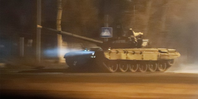 A tank drives along a street after Russian President Vladimir Putin ordered the deployment of Russian troops to two breakaway regions in eastern Ukraine following the recognition of their independence, in the separatist-controlled city of Donetsk, Ukraine, Feb. 22, 2022. 