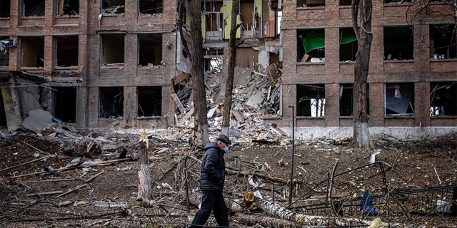 A man walks in front of a destroyed building after a Russian missile attack in the town of Vasylkiv, near Kyiv, on February 27, 2022.