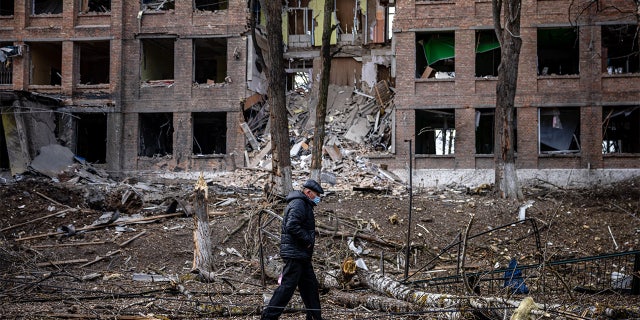 A man walks in front of a destroyed building after a Russian missile attack in the town of Vasylkiv, near Kyiv, on February 27, 2022.