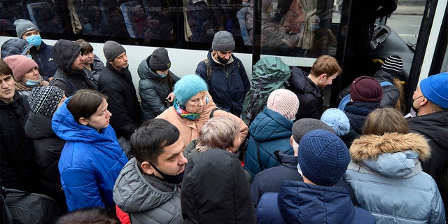 KYIV, UKRAINE - Feb. 24: People board a bus as they attempt to evacuate the city on Feb. 24, 2022 in Kyiv, Ukraine. Overnight, Russia began a large-scale attack on Ukraine, with explosions reported in multiple cities and far outside the restive eastern regions held by Russian-backed rebels. 