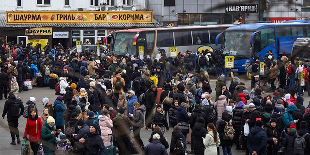 People wait for buses at a bus station as they attempt to evacuate the city Feb. 24, 2022, in Kyiv, Ukraine. Overnight, Russia began a large-scale attack on Ukraine, with explosions reported in multiple cities and far outside the restive eastern regions held by Russian-backed rebels. 