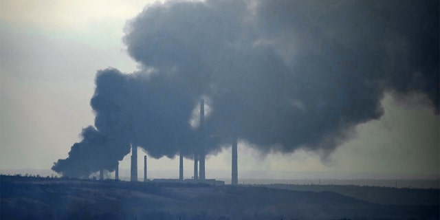 Smoke billows from a power and heating plant after it was shelled in Shchastya, in the Luhansk region, eastern Ukraine, Tuesday, Feb. 22, 2022.