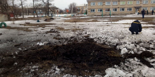 A view shows a crater, caused by shelling according to Ukraine's local officials, at the compound of a lyceum in the town of Vrubivka, in the Luhansk region, Ukraine.