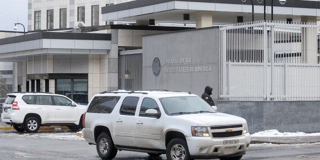 A diplomatic car drives out of the territory of the U.S. embassy in Kyiv, Ukraine Feb. 12, 2022.