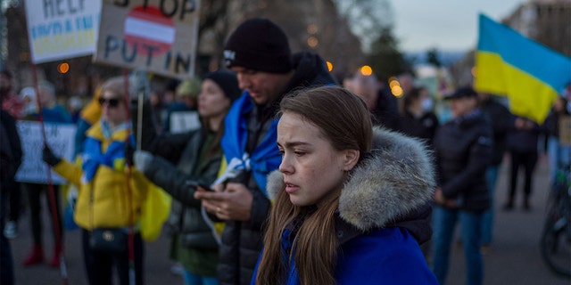 A woman stands with other activists during a protest against Russian invasion of Ukraine during a rally at Lafayette Square, across from the White House, in Washington, D.C., on Feb. 25, 2022.