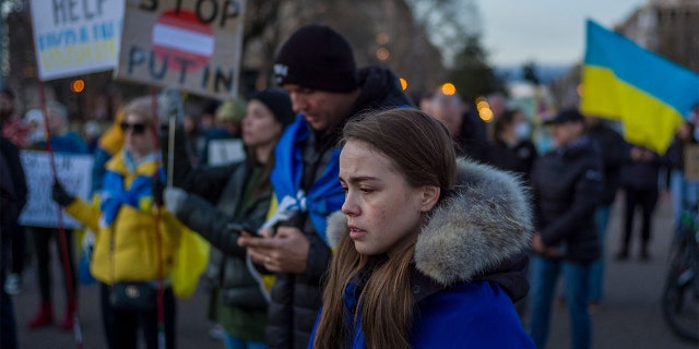 A woman stands with other activists during a protest against Russian invasion of Ukraine during a rally at Lafayette Square, across from the White House, in Washington, D.C., on Feb. 25, 2022.