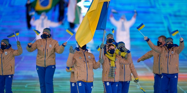 Oleksandr Abramenko and Oleksandra Nazarova, of Ukraine, lead their team in during the opening ceremony of the 2022 Winter Olympics, Friday, Feb. 4, 2022, in Beijing.