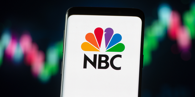 In this photo illustration a NBC logo seen displayed on a smartphone. 
