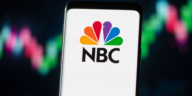 In this photo illustration a NBC logo seen displayed on a smartphone. 